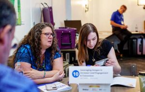 Leah Fellows having a discussion at a conference table